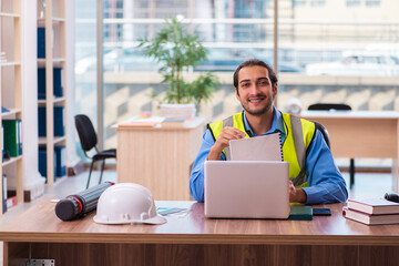 Young male architect working in the office