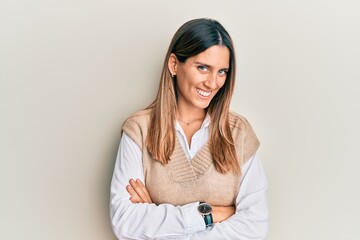 Brunette young woman wearing casual clothes happy face smiling with crossed arms looking at the camera. positive person.