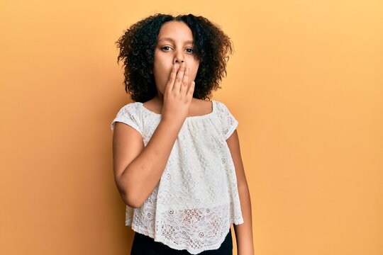 Young little girl with afro hair wearing casual clothes bored yawning tired covering mouth with hand. restless and sleepiness.