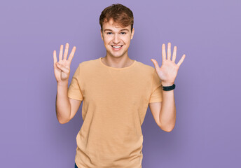 Young caucasian man wearing casual clothes showing and pointing up with fingers number nine while...