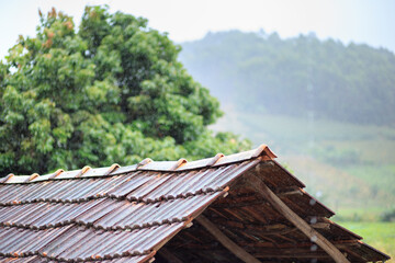 Fototapeta na wymiar Rain on old roof of a house