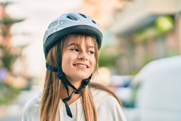 Caucasian sporty teenager girl smiling happy wearing bike helmet at the city.