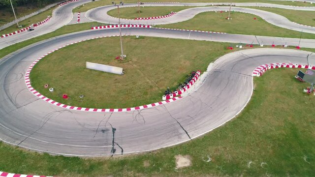 Karting race track, aerial view 4k video. Competition. Buggy kart racing around curves.