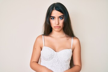 Brunette teenager girl posing elegant depressed and worry for distress, crying angry and afraid....
