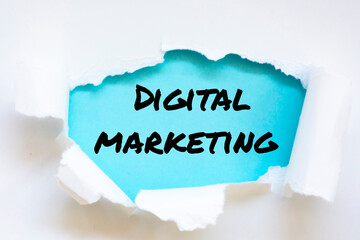 Digital Marketing word written under torn paper.