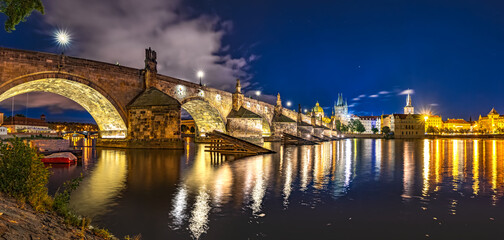Fototapeta na wymiar Illuminated Stone Arches of Charles Bridge, Medieval Gothic Architecture, Part of the Cultural Heritage of Prague