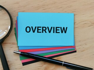 Selective focus phrase Overview written on blue card with a pen and magnifying glass.
