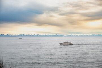  the boat sails on lake Baikal / mountains in the distance