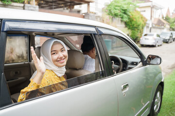 Muslim family travel by car during eid mubarak celebration. asian people going back to their hometown