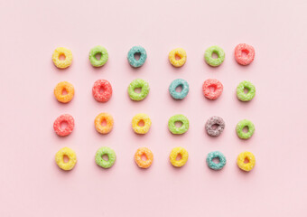 Tasty cereal rings on color background