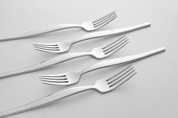 Stylish forks on light background