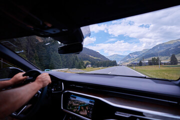 Beautiful landscape. A road through the Swiss Alps viewed from inside the car.