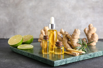 Bottles with ginger essential oil on dark background
