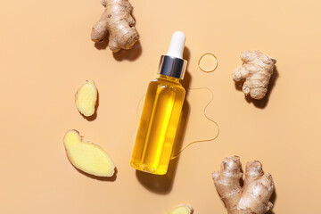 Bottle with ginger essential oil on color background