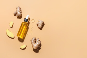 Bottle with ginger essential oil on color background