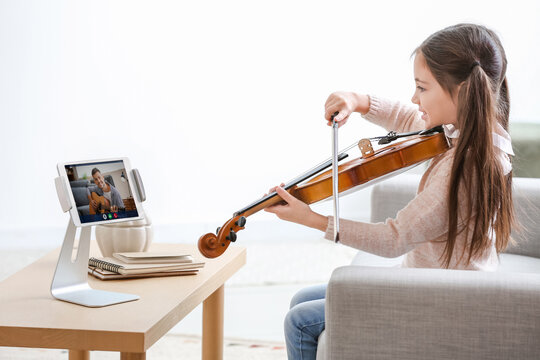 Little Girl Taking Music Lessons Online At Home