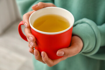 Woman with cup of hot tea, closeup