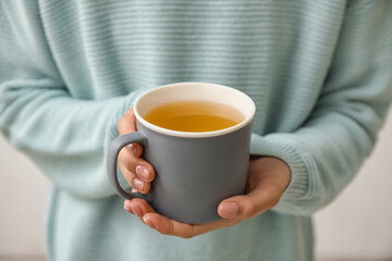 Woman with cup of hot tea, closeup