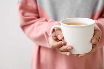 Woman with cup of hot tea, closeup