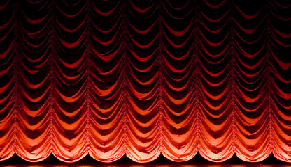 A red theater curtain in a cinema