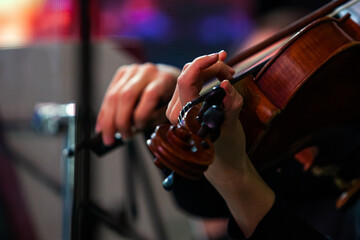 Hands of a musician playing the violin close up