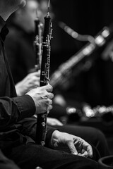 Oboe in the hands of a musician in an orchestra in black and white