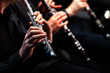 Hands of a musician playing the flute in an orchestra
- 417054379