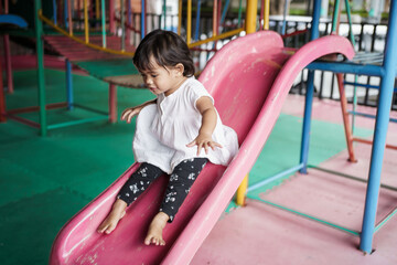 Fototapeta na wymiar happy face of toddler on the playground sliding