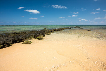 Hidden beach with stone platform that separates the sea from the sand and invites us to relax on a beautiful sunny day. Iriomote Island.