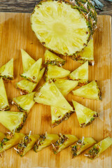 Close up slices of pineapple on wooden board