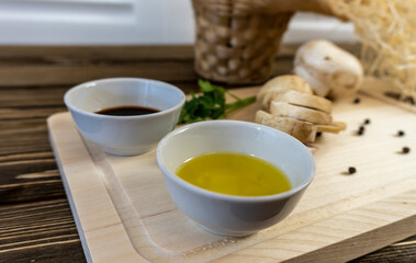 Still life, Food photo of mushrooms champignons. Mushrooms whole and chopped, basket with mushrooms