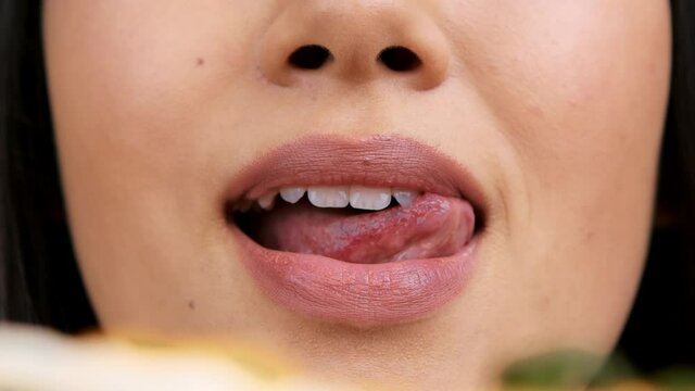 Closeup Of Asian Woman Licking Lips Sensually Eating Hot Pizza