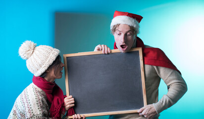 santa claus with a blackboard. Couple in love. Gifts. Happy day. Love. Sale. 