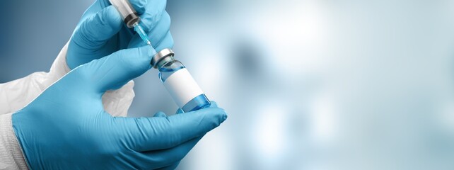 Human hand with injection syringe and vaccine