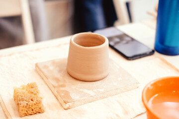 hand modeling from clay. Clay mug. Mug - handmade. Clay work in the workshop