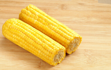 Boiled corn pob and sweet popcorn. Ears of cooked sweet