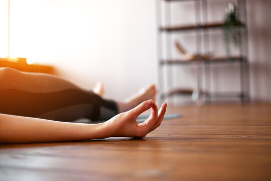 Young attractive woman practicing yoga, Savasana pose