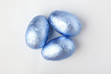 Sweet chocolate eggs on white background