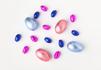 Sweet chocolate eggs on white background