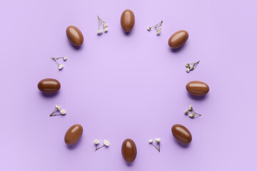 Composition with chocolate Easter eggs on color background