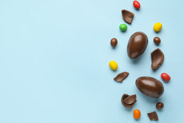 Composition with chocolate Easter eggs on color background