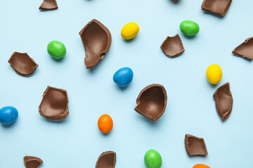 Composition with chocolate Easter eggs on color background
