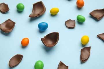 Composition with chocolate Easter eggs on color background