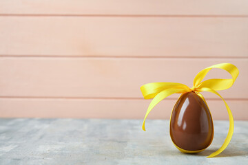 Chocolate Easter egg with ribbon on table