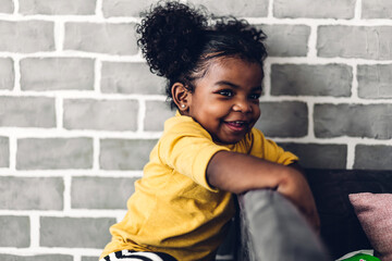 Portrait of happy smiling little child african american girl at home