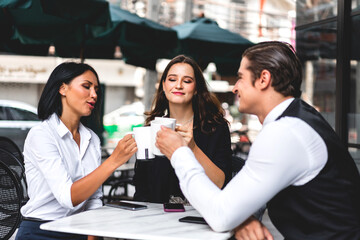 Group of cheerful young friend discussing meeting and talk enjoying their time drinking coffee together.Mixed race people sitting at cafe table and restaurant