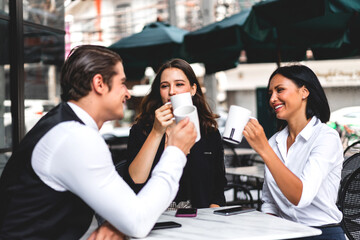 Group of cheerful young friend discussing meeting and talk enjoying their time drinking coffee together.Mixed race people sitting at cafe table and restaurant