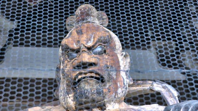 Nara,Japan-november 16, 2020: Honeybees nesting inside a wooden statue of the Deva Kings as temple guardians or Nio standing statue in Taimadera temple in Nara, Japan
