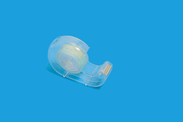 scotch tape dispenser isolated on blue background