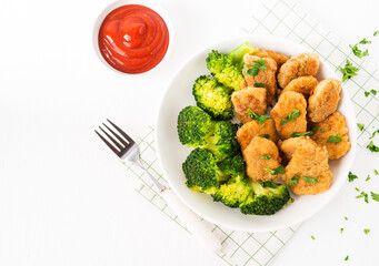 Chicken nuggets with vegetables, broccoli and ketchup on a white background, copy space